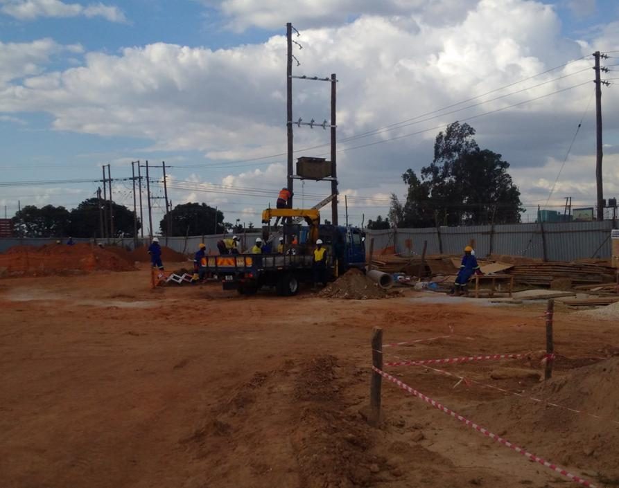 Overhead line construction crew at an industrial site